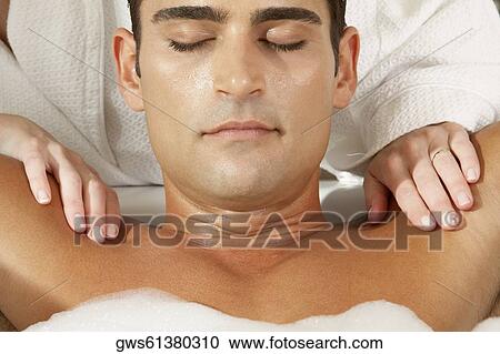 Close-up of a young man getting a massage from a massage therapist View Large Photo Image Stock Image - Close-up of a young man getting a massage from a massage therapist. Fotosearch