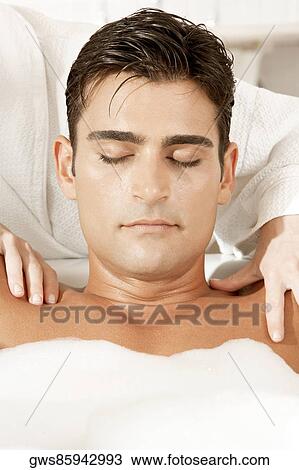 Close-up of a young man getting a massage from a massage therapist View Large Photo Image Stock Image - Close-up of a young man getting a massage from a massage therapist. Fotosearch