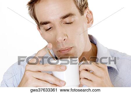 Close-up of a young man holding a cup of tea View Large Photo Image Stock Image - Close-up of a young man holding a cup of tea. Fotosearch