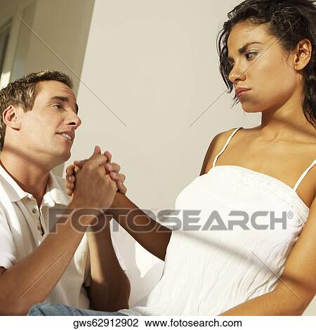 Close-up of a young man holding a young woman's hand View Large Photo Image Stock Image - Close-up of a young man holding a young woman's hand. Fotosearch