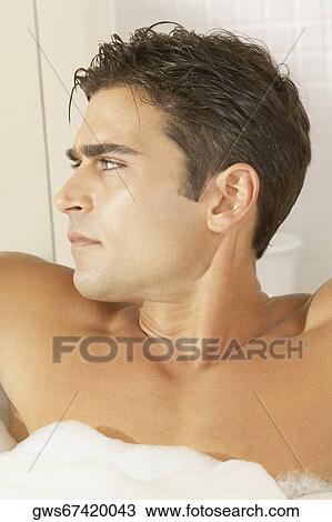 Close-up of a young man in a bathtub View Large Photo Image Stock Image - Close-up of a young man in a bathtub. Fotosearch