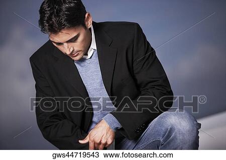 Close-up of a young man looking down View Large Photo Image Stock Image - Close-up of a young man looking down. Fotosearch