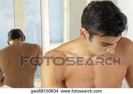 Close-up of a young man looking pensive View Large Photo Image Picture - Close-up of a young man looking pensive. Fotosearch
