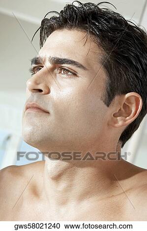 Close-up of a young man looking serious View Large Photo Image Stock Image - Close-up of a young man looking serious. Fotosearch