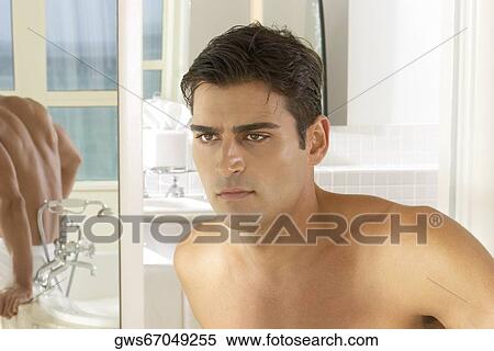 Close-up of a young man looking serious View Large Photo Image Stock Photography - Close-up of a young man looking serious. Fotosearch