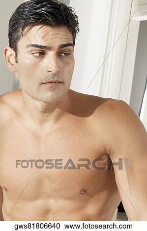 Close-up of a young man looking sideways View Large Photo Image Stock Image - Close-up of a young man looking sideways. Fotosearch