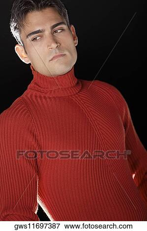 Close-up of a young man looking sideways View Large Photo Image Stock Photo - Close-up of a young man looking sideways. Fotosearch