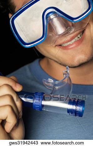 Close-up of a young man wearing a scuba mask holding a snorkel View Large Photo Image Stock Image - Close-up of a young man wearing a scuba mask holding a snorkel. Fotosearch