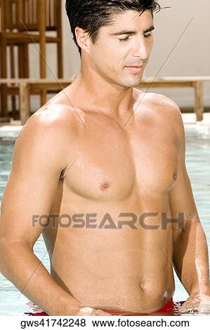 Stock Photo - Close-up of a young man with his eyes closed in a swimming pool. Fotosearch