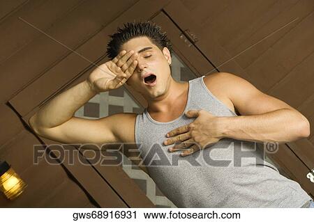 Close-up of a young man yawning View Large Photo Image Stock Image - Close-up of a young man yawning. Fotosearch