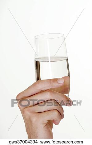Close-up of a young man's hand holding a glass of water View Large Photo Image Picture - Close-up of a young man's hand holding a glass of water. Fotosearch