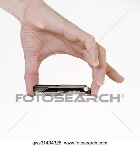 Close-up of a young man's hand holding a mobile phone View Large Photo Image Stock Photograph - Close-up of a young man's hand holding a mobile phone. Fotosearch