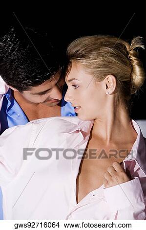 Close-up of a young woman and a mid adult man embracing each other View Large Photo Image Picture - Close-up of a young woman and a mid adult man embracing each other. Fotosearch