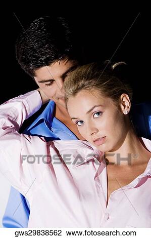 Close-up of a young woman and a mid adult man embracing each other View Large Photo Image Stock Image - Close-up of a young woman and a mid adult man embracing each other. Fotosearch
