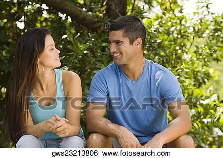 Close-up of a young woman and a mid adult man looking at each other View Large Photo Image Stock Photograph - Close-up of a young woman and a mid adult man looking at each other. Fotosearch