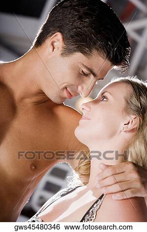 Close-up of a young woman and a mid adult man embracing each other View Large Photo Image Stock Photograph - Close-up of a young woman and a mid adult man embracing each other. Fotosearch