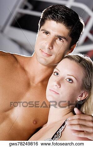 Close-up of a young woman and a mid adult man looking away View Large Photo Image Stock Photograph - Close-up of a young woman and a mid adult man looking away. Fotosearch