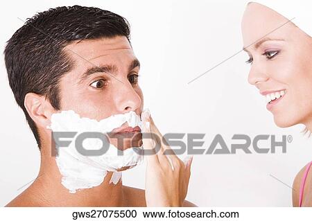 Close-up of a young woman applying shaving cream on a mid adult man's face View Large Photo Image Stock Image - Close-up of a young woman applying shaving cream on a mid adult man's face. Fotosearch