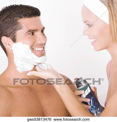 Close-up of a young woman applying shaving cream on a mid adult man's face View Large Photo Image Stock Photograph - Close-up of a young woman applying shaving cream on a mid adult man's face. Fotosearch