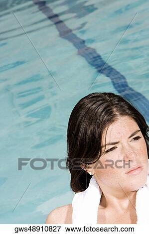 Stock Photo - Close-up of a young woman at the poolside. Fotosearch