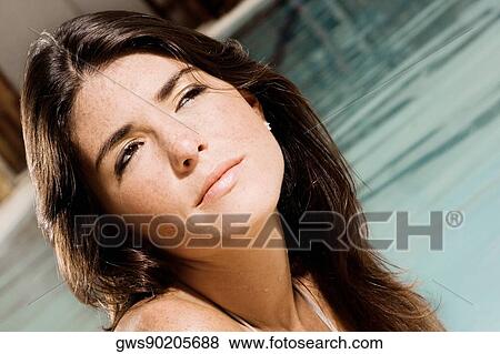 Close-up of a young woman at the poolside View Large Photo Image Stock Photo - Close-up of a young woman at the poolside. Fotosearch