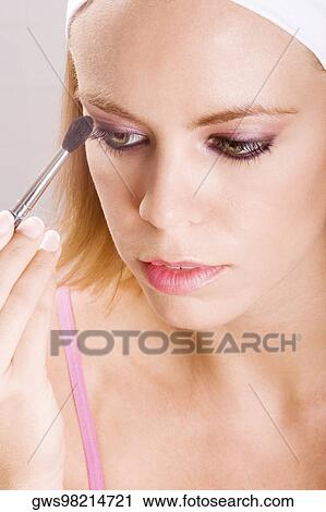 Close-up of a young woman brushing her eyebrow View Large Photo Image Stock Image - Close-up of a young woman brushing her eyebrow. Fotosearch
