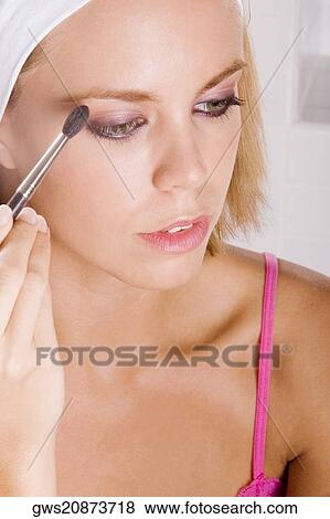 Close-up of a young woman brushing her eyebrow View Large Photo Image Stock Photo - Close-up of a young woman brushing her eyebrow. Fotosearch