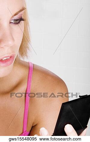 Close-up of a young woman brushing her eyebrow View Large Photo Image Stock Photography - Close-up of a young woman brushing her eyebrow. Fotosearch