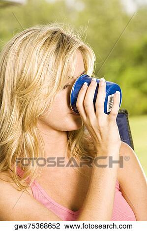 Close-up of a young woman drinking a cup of coffee View Large Photo Image Stock Image - Close-up of a young woman drinking a cup of coffee. Fotosearch