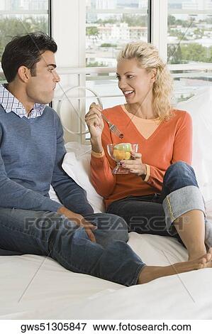 Stock Photo - Close-up of a young woman feeding salad to a young man. Fotosearch