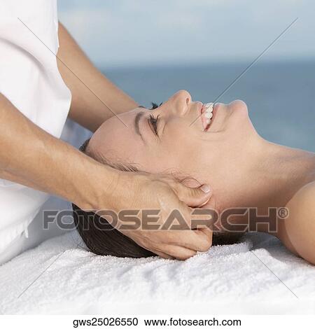 Close-up of a young woman getting a head massage View Large Photo Image Stock Image - Close-up of a young woman getting a head massage. Fotosearch