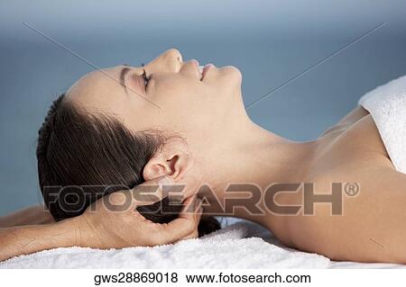 Close-up of a young woman getting a head massage View Large Photo Image Stock Photo - Close-up of a young woman getting a head massage. Fotosearch