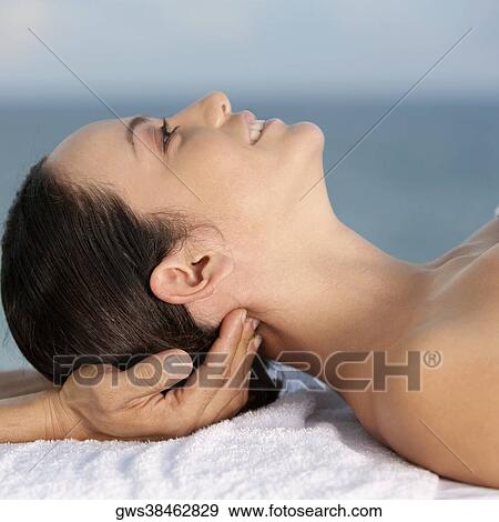 Close-up of a young woman getting a neck massage View Large Photo Image Stock Photo - Close-up of a young woman getting a neck massage. Fotosearch