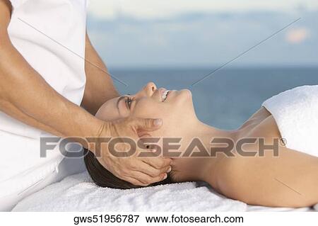 Close-up of a young woman getting a head massage View Large Photo Image Stock Photo - Close-up of a young woman getting a head massage. Fotosearch