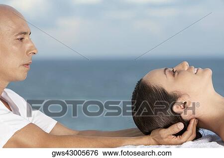 Close-up of a young woman getting a head massage View Large Photo Image Stock Photograph - Close-up of a young woman getting a head massage. Fotosearch