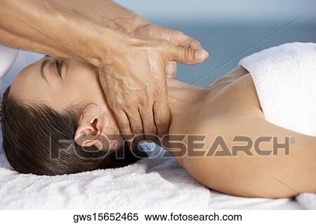 Close-up of a young woman getting a neck massage View Large Photo Image Stock Photography - Close-up of a young woman getting a neck massage. Fotosearch