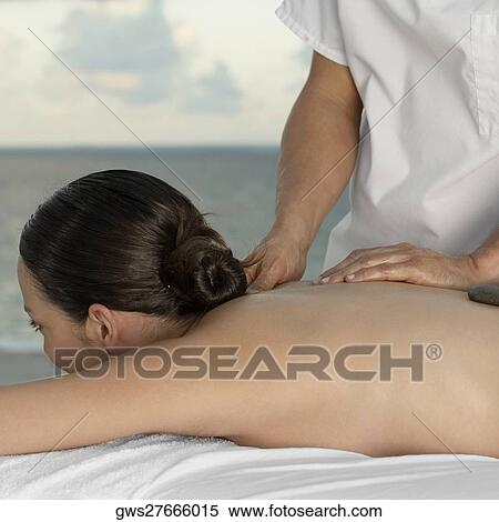 Close-up of a young woman getting a back massage View Large Photo Image Stock Photography - Close-up of a young woman getting a back massage. Fotosearch