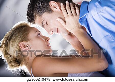 Close-up of a young woman holding a mid adult man's face View Large Photo Image Stock Photo - Close-up of a young woman holding a mid adult man's face. Fotosearch