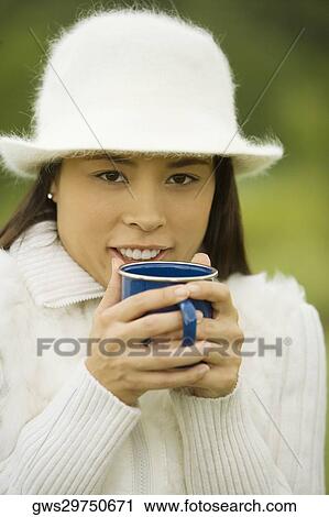 Close-up of a young woman holding a coffee cup View Large Photo Image Stock Image - Close-up of a young woman holding a coffee cup. Fotosearch