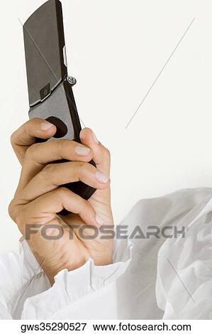 Stock Photo - Close-up of a young woman holding a mobile phone. Fotosearch