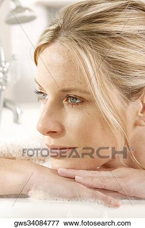 Close-up of a young woman in a bathtub View Large Photo Image Stock Photo - Close-up of a young woman in a bathtub. Fotosearch