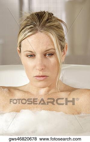 Close-up of a young woman in a bathtub View Large Photo Image Stock Photo - Close-up of a young woman in a bathtub. Fotosearch