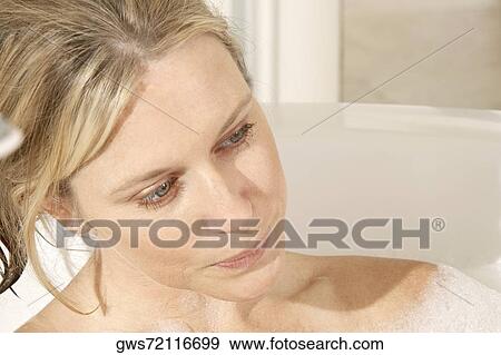 Close-up of a young woman in a bathtub View Large Photo Image Stock Photo - Close-up of a young woman in a bathtub. Fotosearch