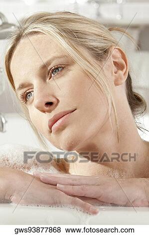 Close-up of a young woman in a bathtub View Large Photo Image Stock Photo - Close-up of a young woman in a bathtub. Fotosearch