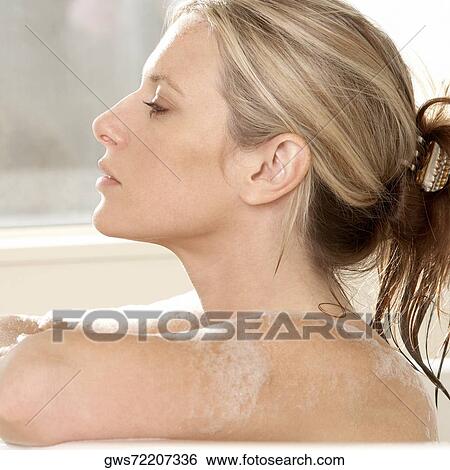 Close-up of a young woman in a bathtub View Large Photo Image Stock Photograph - Close-up of a young woman in a bathtub. Fotosearch