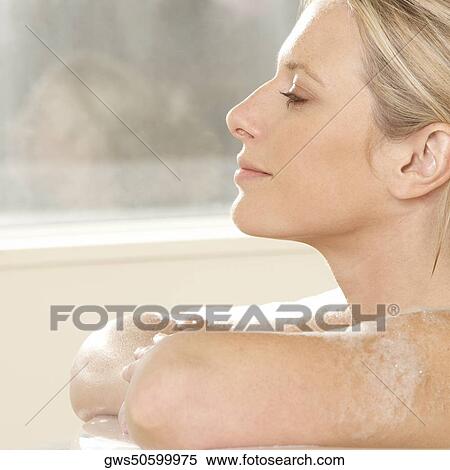 Close-up of a young woman in a bathtub View Large Photo Image Stock Photography - Close-up of a young woman in a bathtub. Fotosearch
