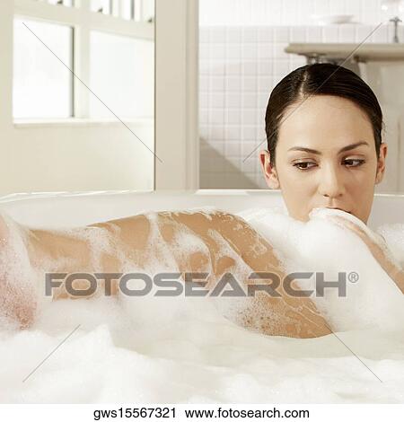 Close-up of a young woman in a bubble bath View Large Photo Image Stock Image - Close-up of a young woman in a bubble bath. Fotosearch