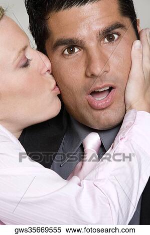 Close-up of a young woman kissing a mid adult man View Large Photo Image Stock Photography - Close-up of a young woman kissing a mid adult man. Fotosearch