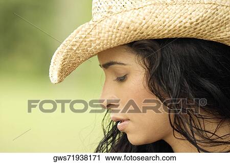 Close-up of a young woman looking down View Large Photo Image Stock Image - Close-up of a young woman looking down. Fotosearch
