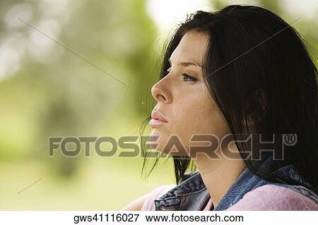 Close-up of a young woman looking serious View Large Photo Image Stock Photo - Close-up of a young woman looking serious. Fotosearch